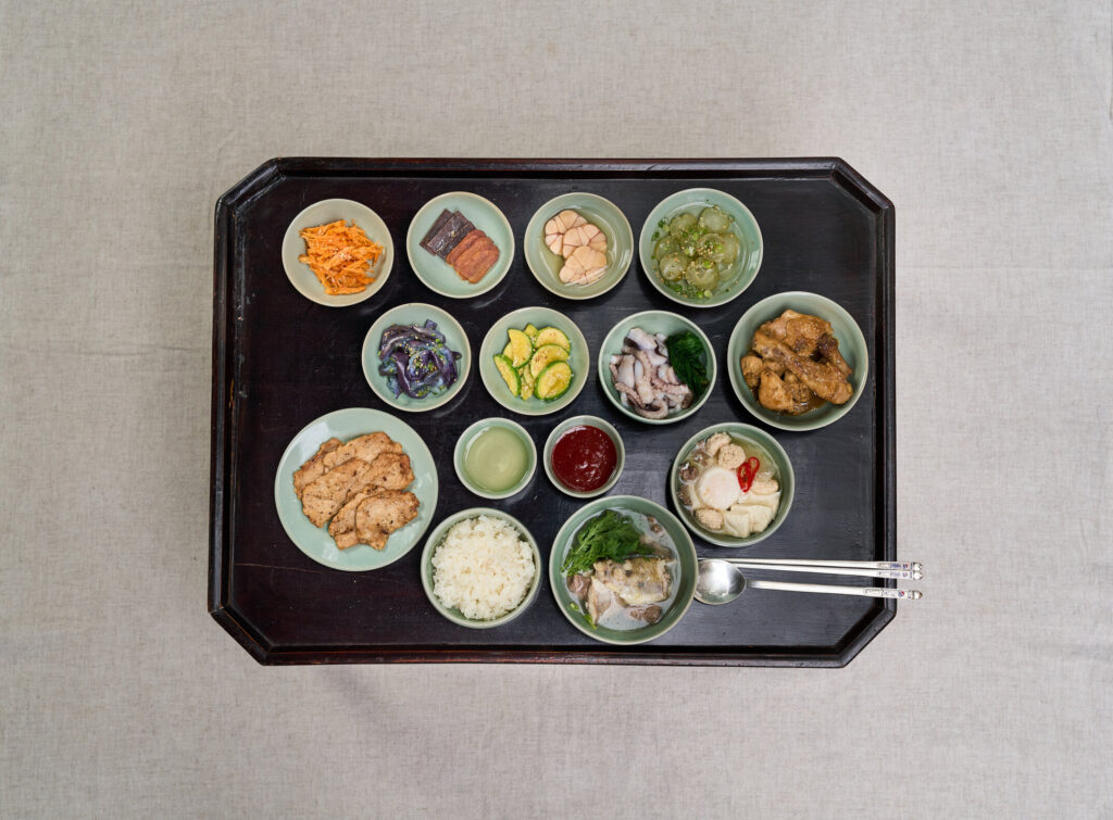 Traditional Joseon yangban aristocrat seasonal dining table showing 9-dish arrangement with regional ingredients : winter