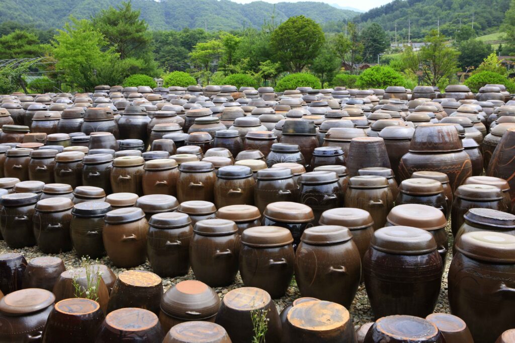 Traditional Korean jangdokdae fermentation platform with hundreds of onggi earthenware jars in Korean countryside