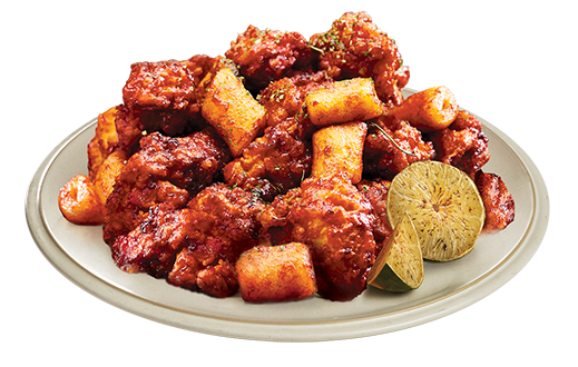 Crispy Korean yangnyeom fried chicken coated in sticky gochujang glaze with sesame seeds on white plate