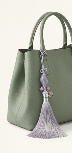 JOYHAN Korean norigae tassel charm as bag charm on green handbag