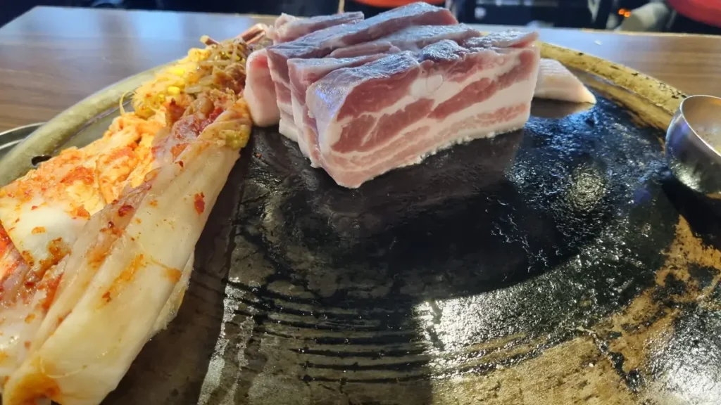 Thick-cut raw pork belly showing the three layers that give samgyeopsal its name