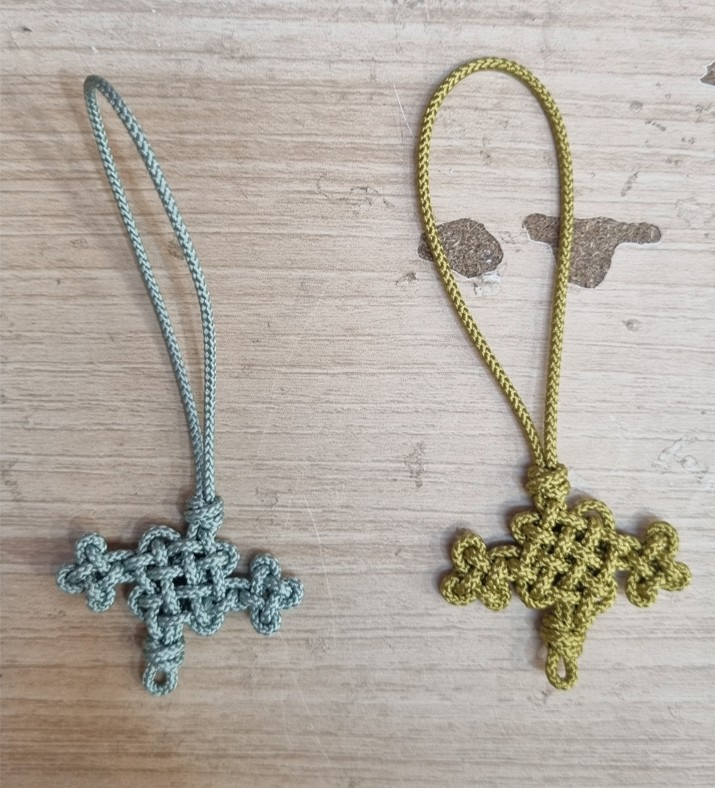 Korean maedeup knots in progress at a craft workshop, showing the hand-tied structure before assembly