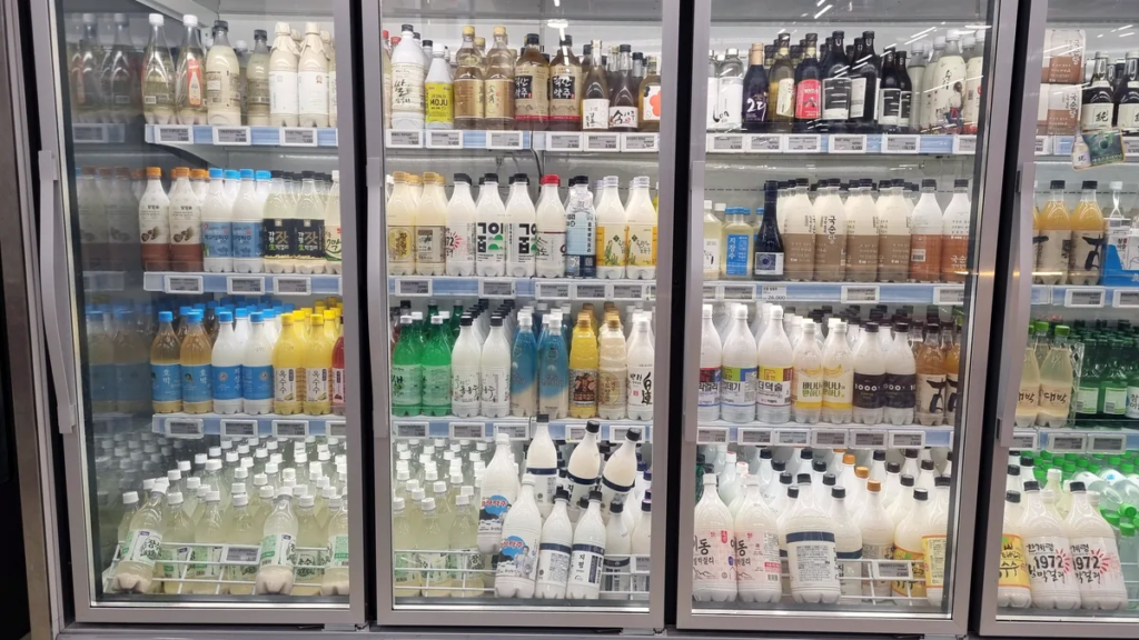 A Korean store refrigerator filled with dozens of different makgeolli and traditional rice wine brands