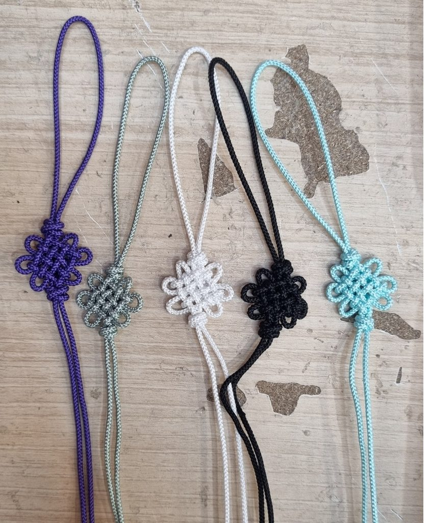 Korean maedeup norigae cords in many colors displayed at a traditional Korean craft market