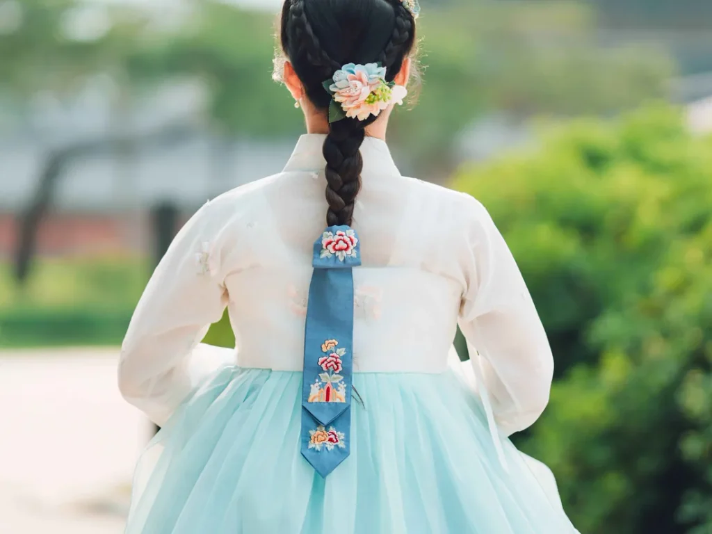 Woman in traditional Korean hanbok with a single long braid and embroidered daenggi ribbon at Changdeokgung Palace